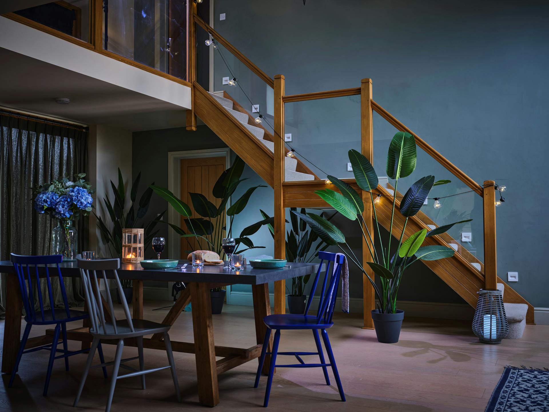 Artificial strelitzia trees in blue dining room