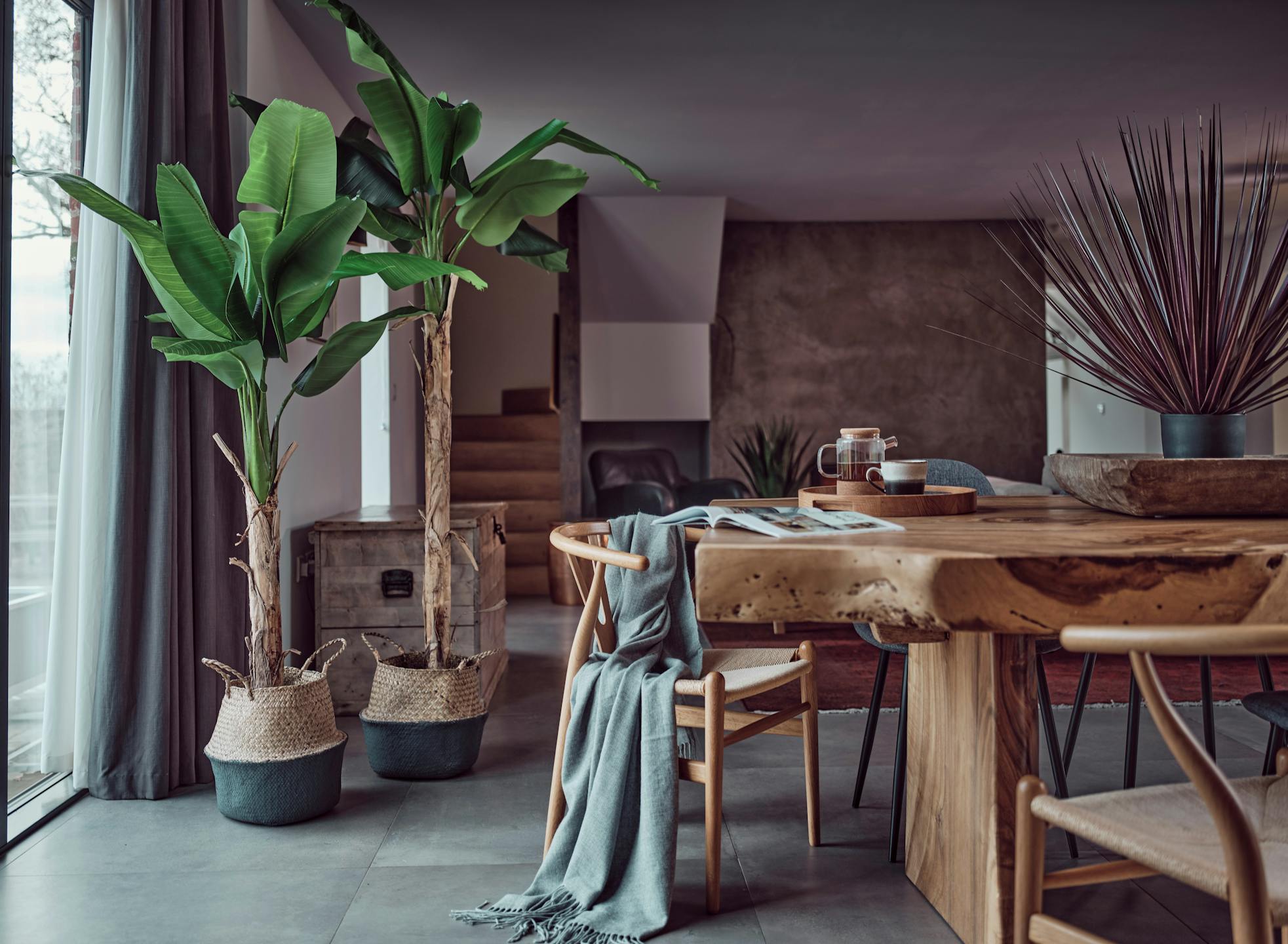 Artificial musa banana trees next to wooden table
