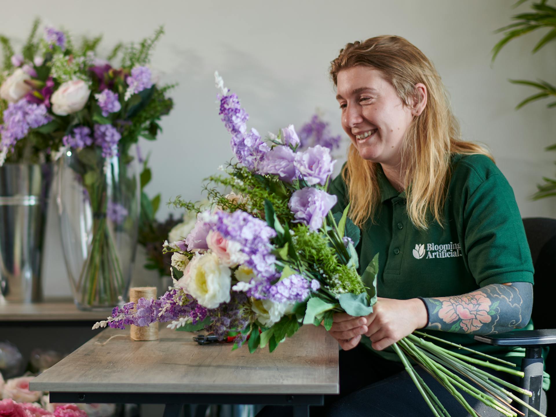 florist arranging flowers into bouquet