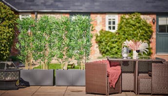 Artificial bamboo in planters screening
