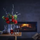 Artificial regal bouquet near fireplace