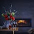Artificial regal bouquet near fireplace