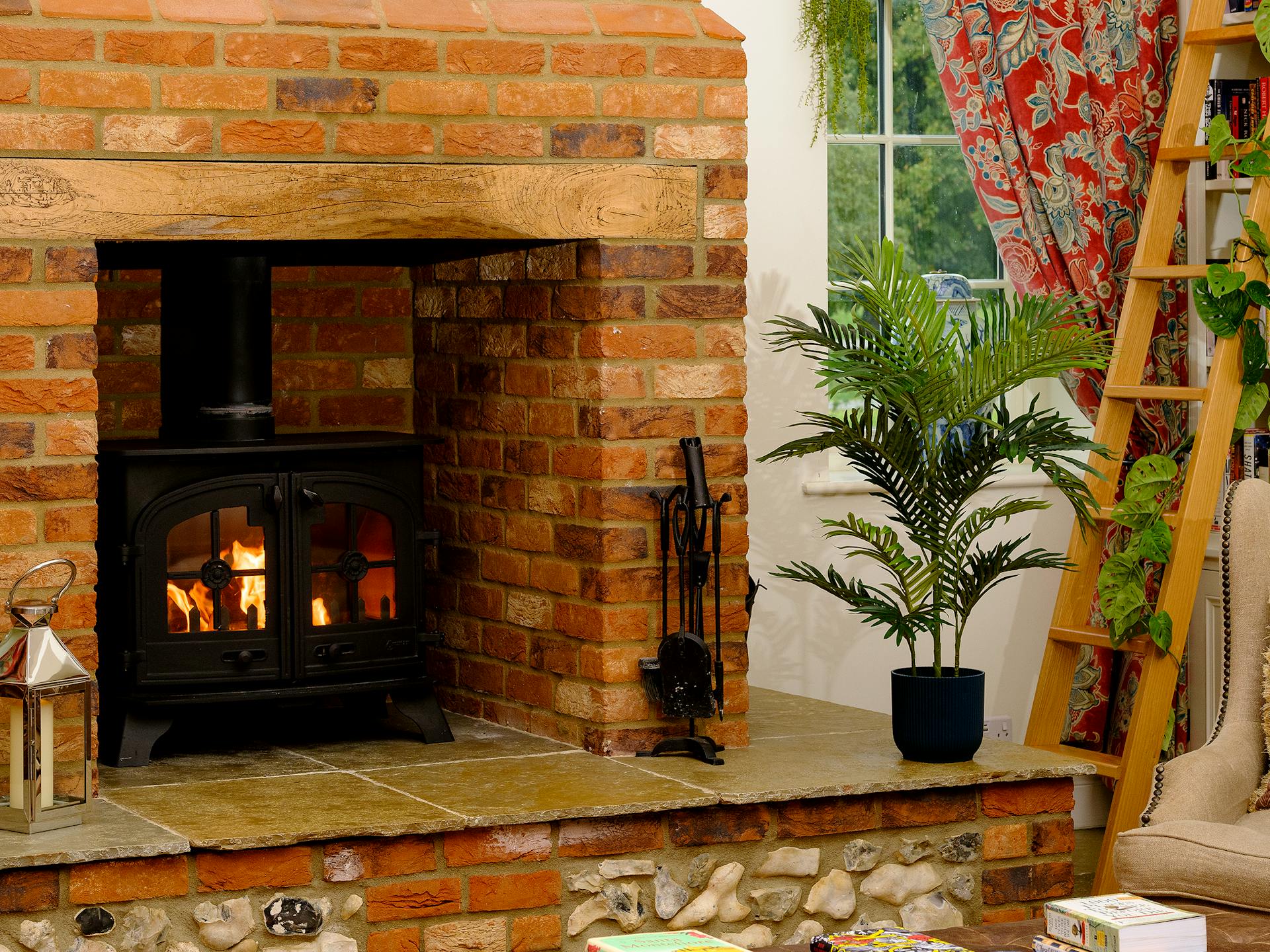 Artificial paradise palm by fireplace