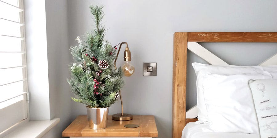 Mini faux Christmas tree in bedroom
