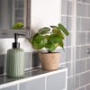 Artificial pilea bush in grey tiled bathroom