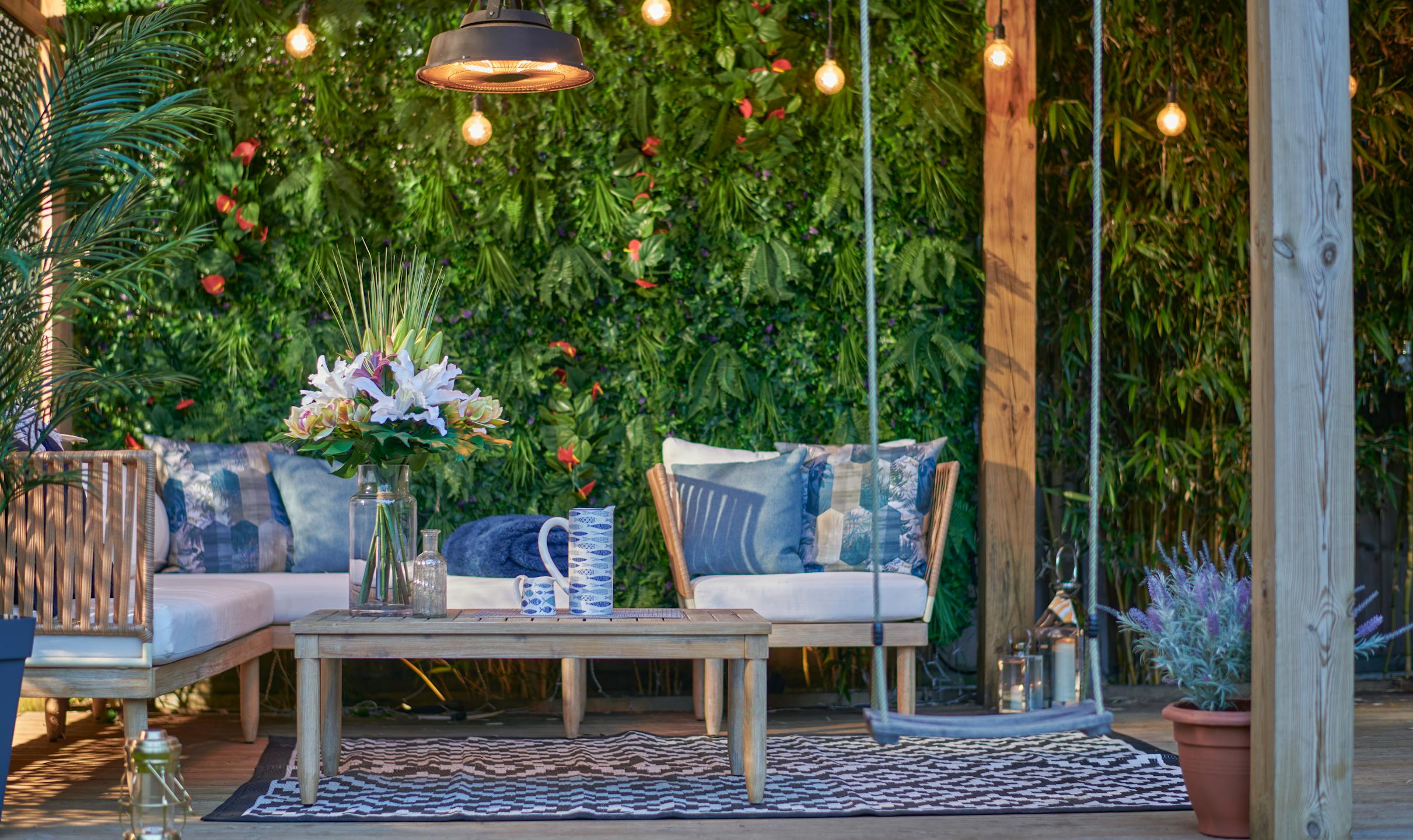 Artificial outdoor seating area with faux bouquet and artificial green wall