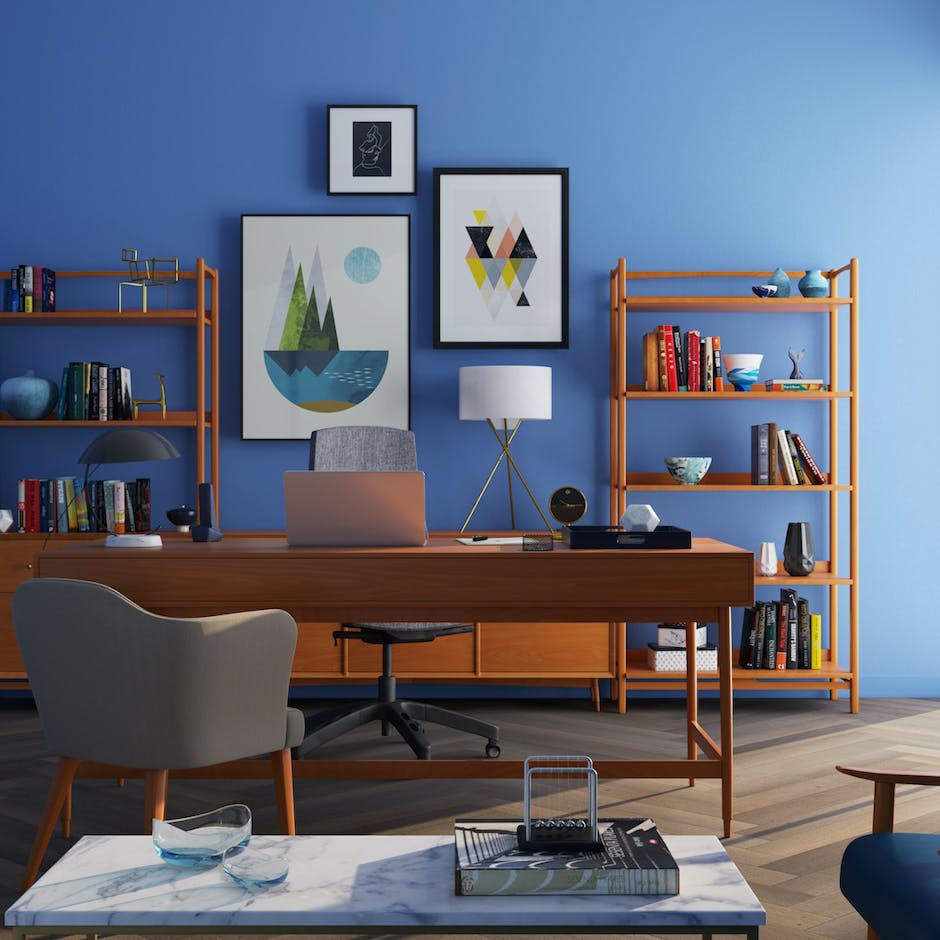 Wooden desk in front of light blue wallpaper