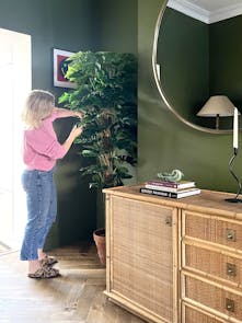 Jess Hurrell arranging artificial cheese plant foliage for winter interior deign tips 2022