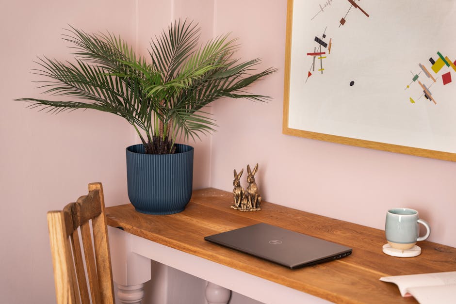 Artificial dwarf palm on home office desk