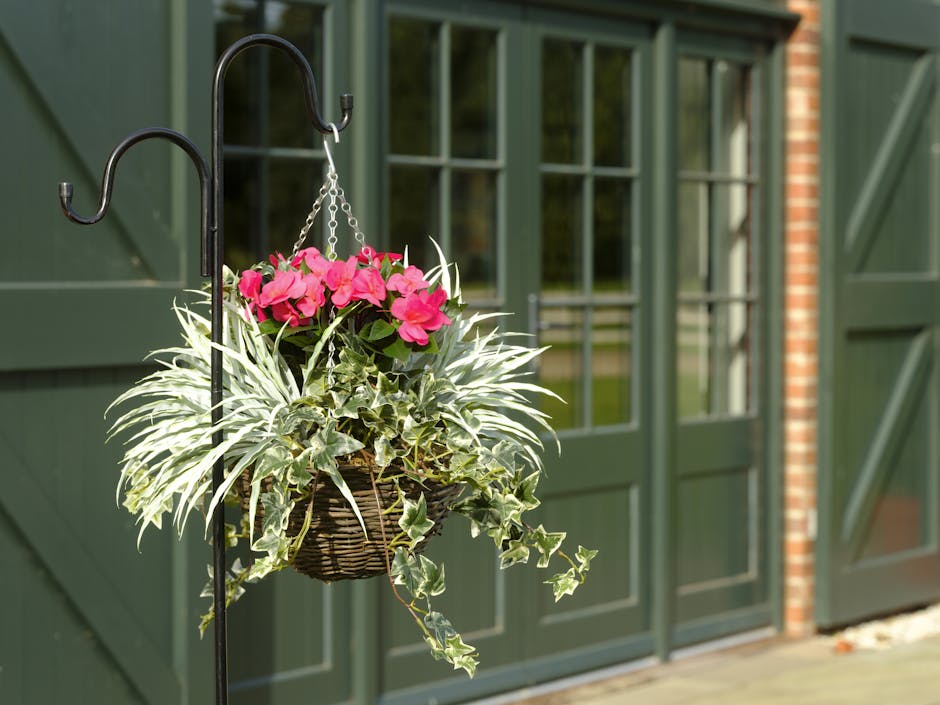 Busy lizzie hanging basket on a hook in front of a barn door