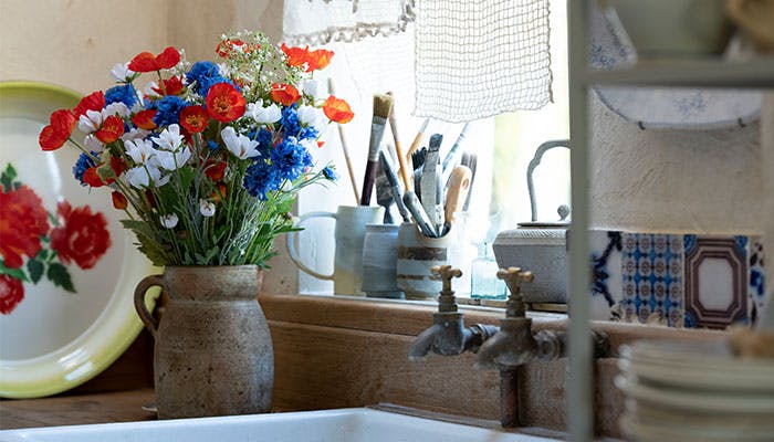 Artificial meadow bouquet by kitchen sink