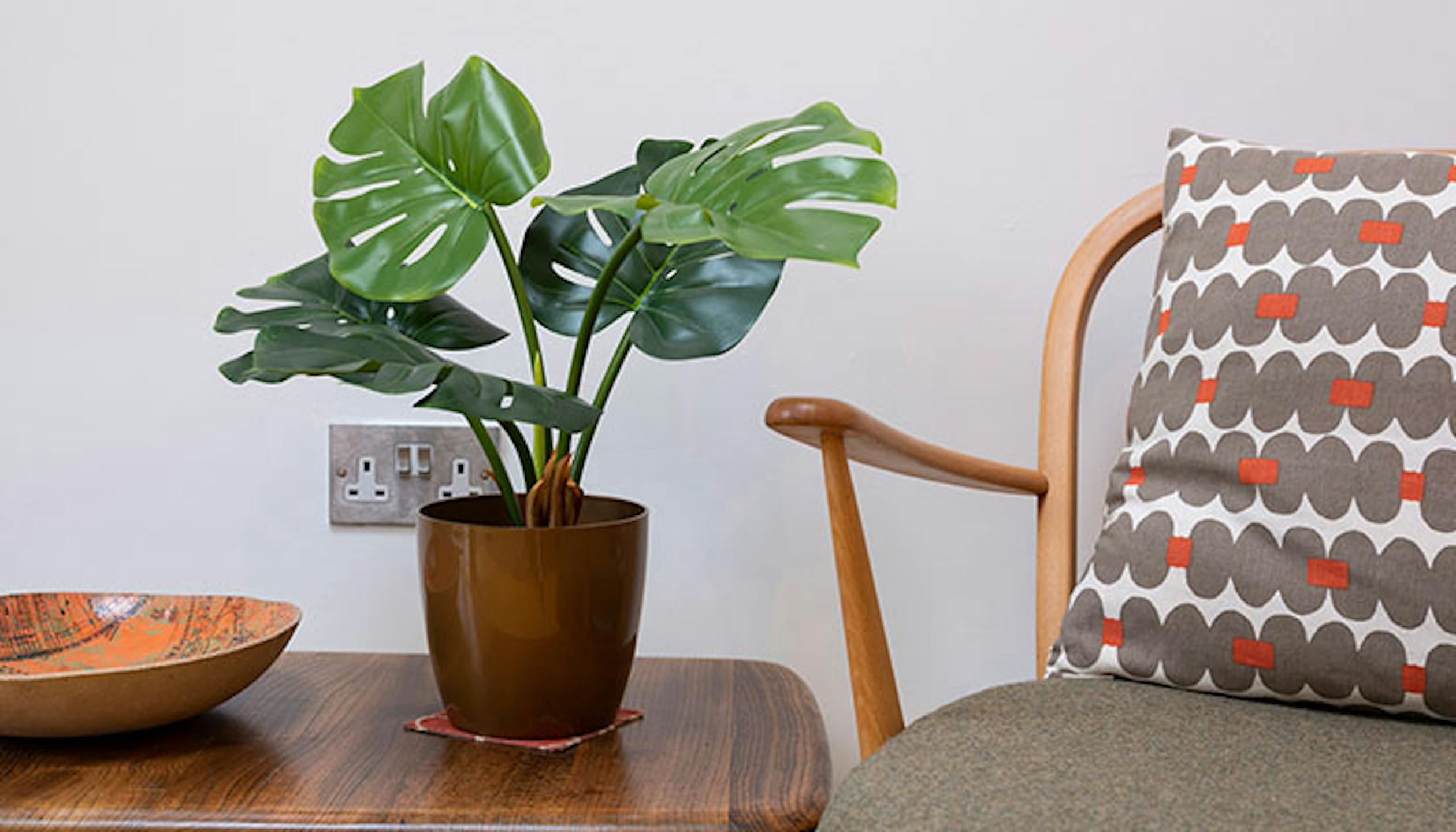 Faux monstera houseplant on table