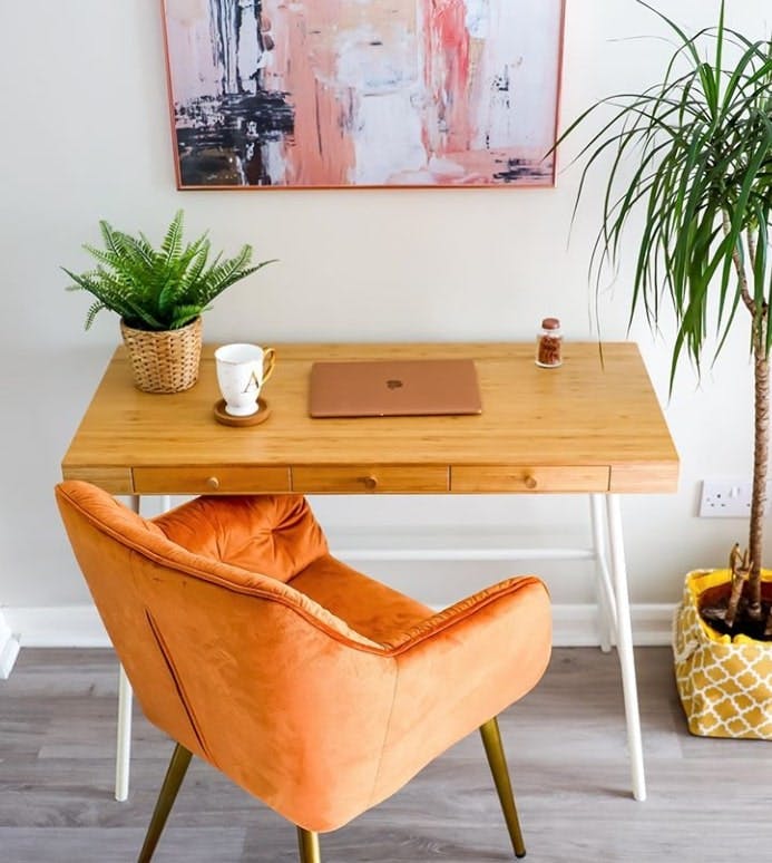 Orange chair by wooden desk