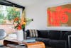 artificial happy orange autumnal arrangement on retro coffee table