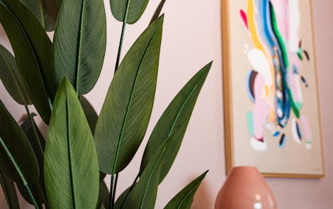 Faux heliconia leaves in pink interior