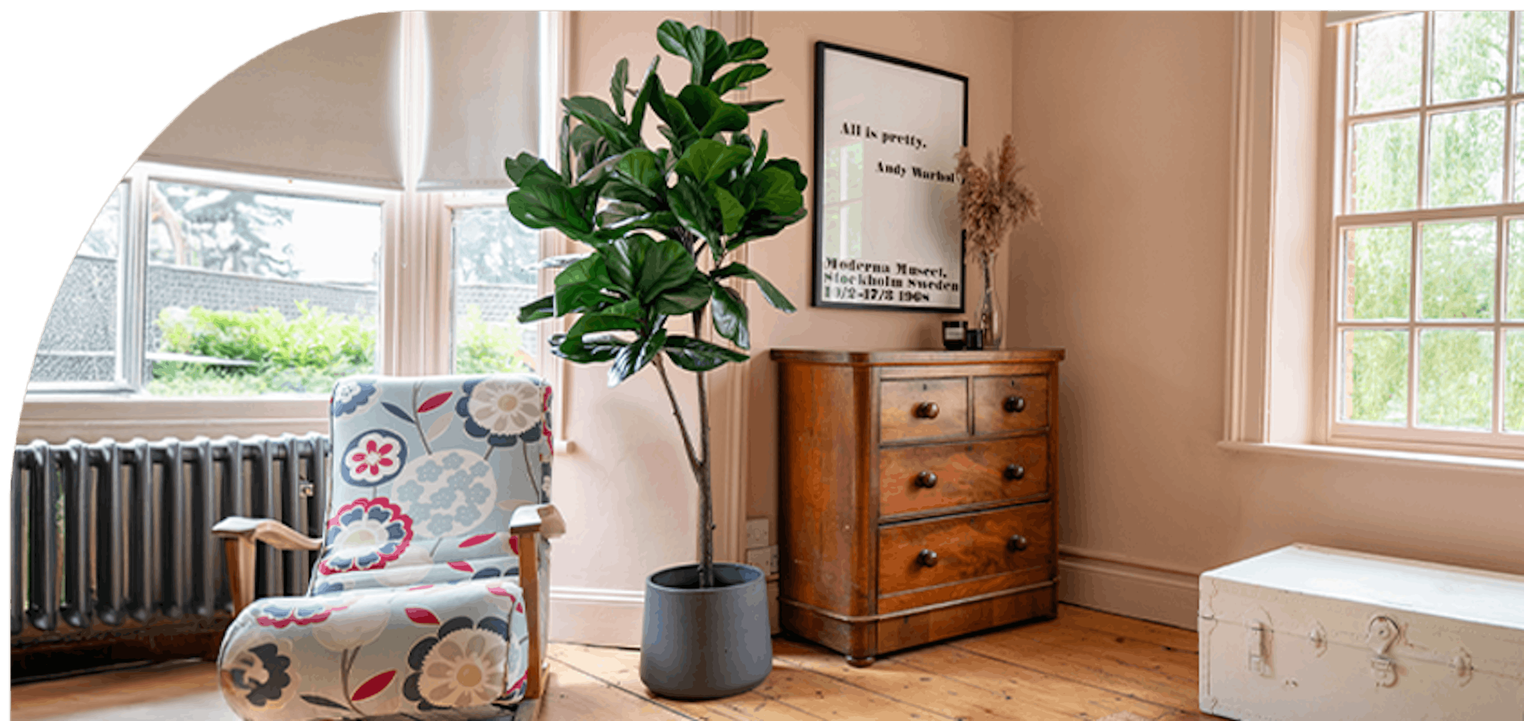 Faux fiddle leaf fig tree in pink bedroom