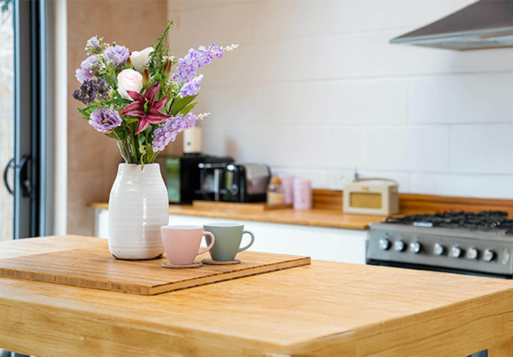 Artificial lilac bunch in kitchen