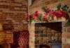 Artificial festive poinsettia fiesta-style garland over fireplace