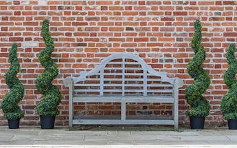 Outdoor artificial trees preview - boxwood spirals by garden bench