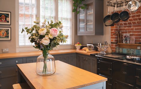 Artificial harmony bouquet on wooden kitchen island