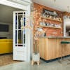 Artificial 185cm peach tropaeolum tree next to wooden indoor bar