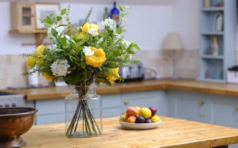 Faux yellow sensational flower bouquet on wood kitchen island