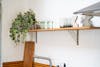 Faux 70cm variegated ivy hanging bush on wooden kitchen shelf against white brick wall