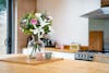 Artificial elegance bouquet on wooden kitchen island