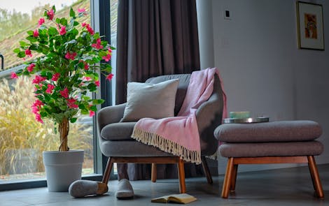 How to arrange artificial plants banner image showing fake bougainvillea in lounge