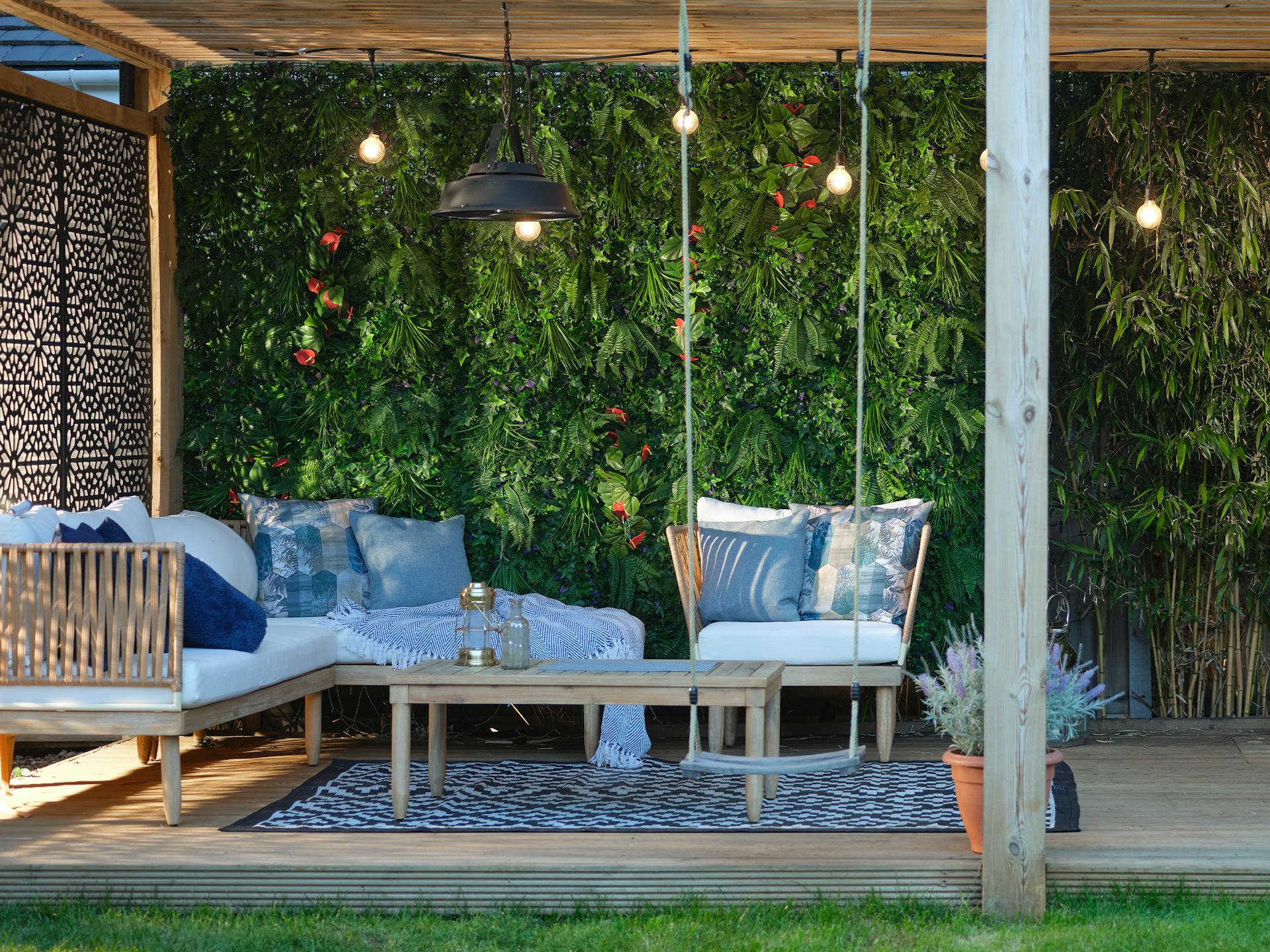 Artificial tropical living wall in outdoor garden seating area