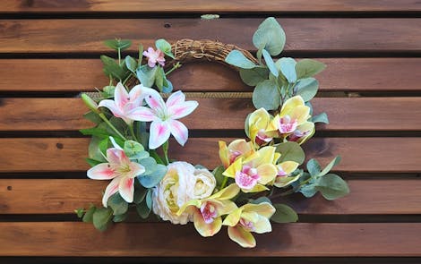 Artificial DIY wreath on wooden background