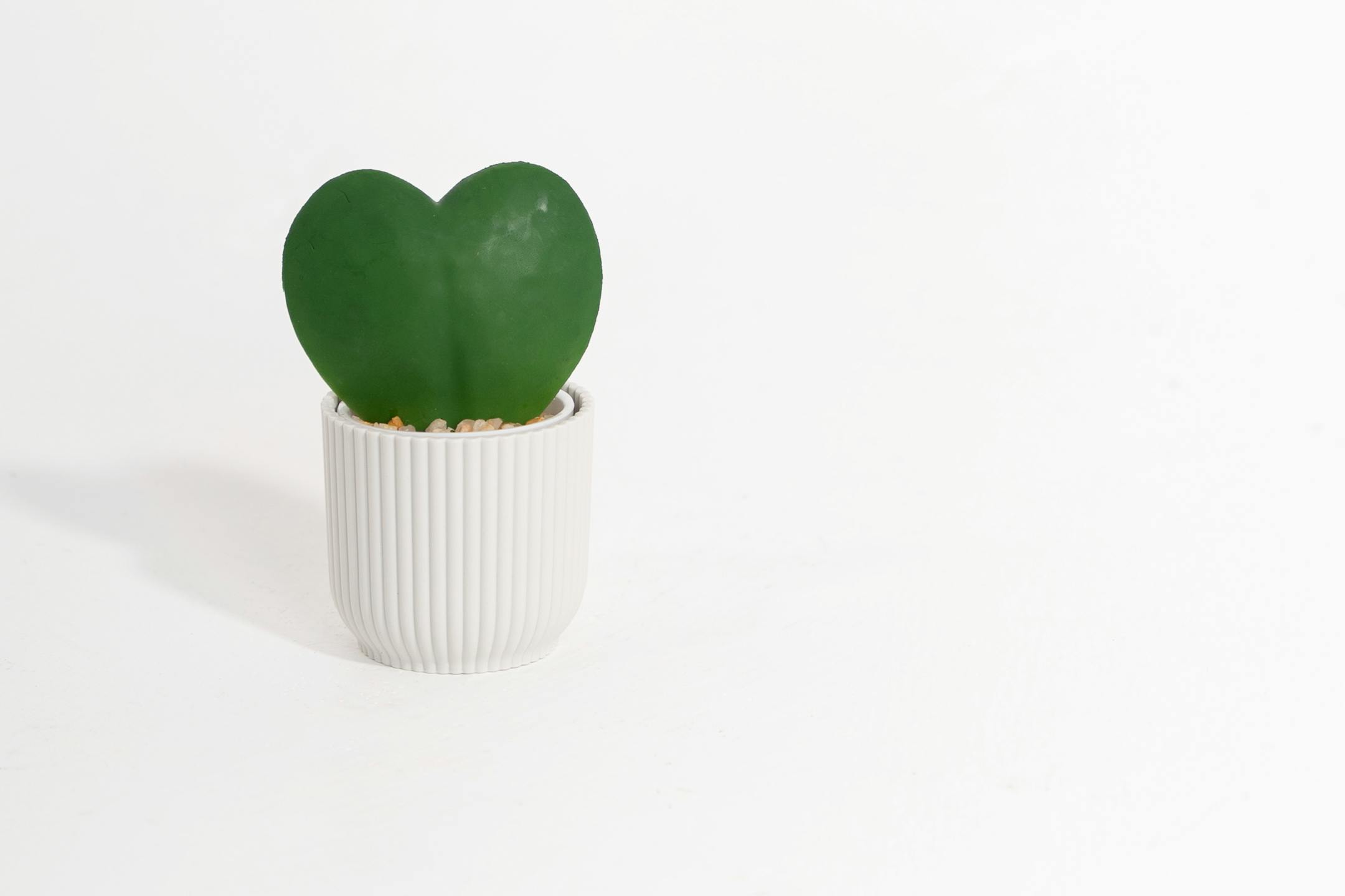 Artificial hoya heart plant in white pot