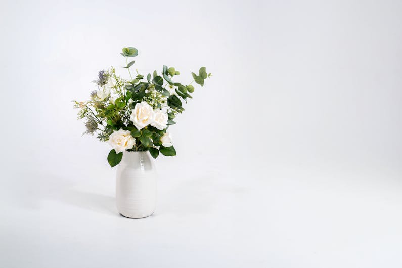 Faux enchanting bunch in white ceramic vase