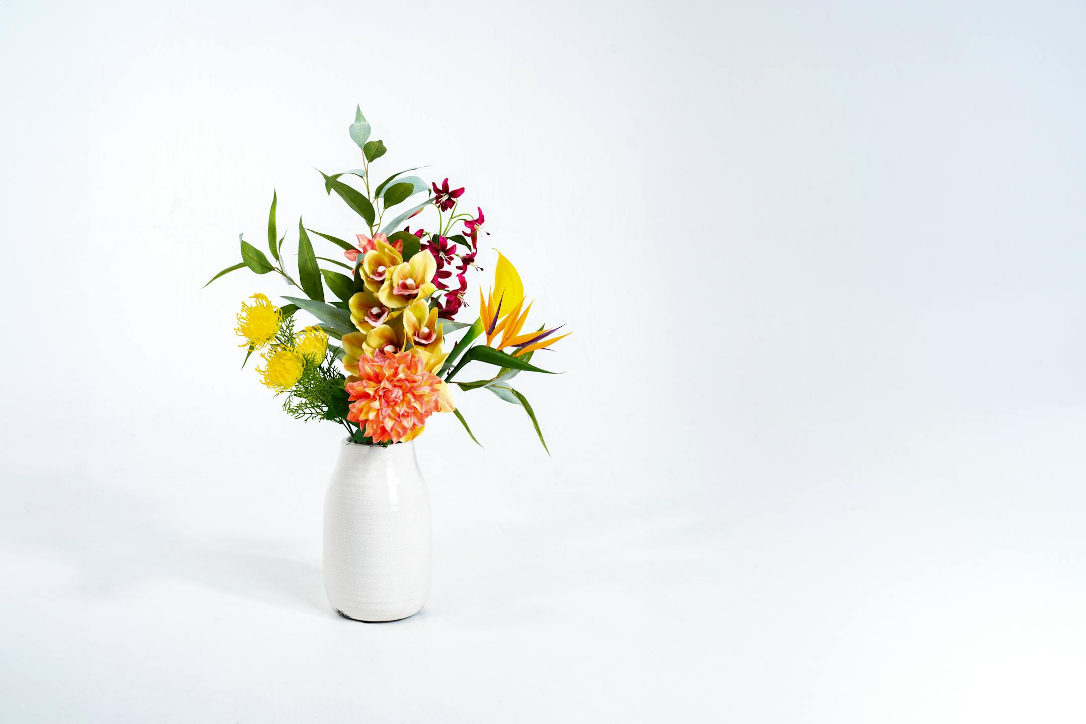 Faux Hawaiian bunch in white vase