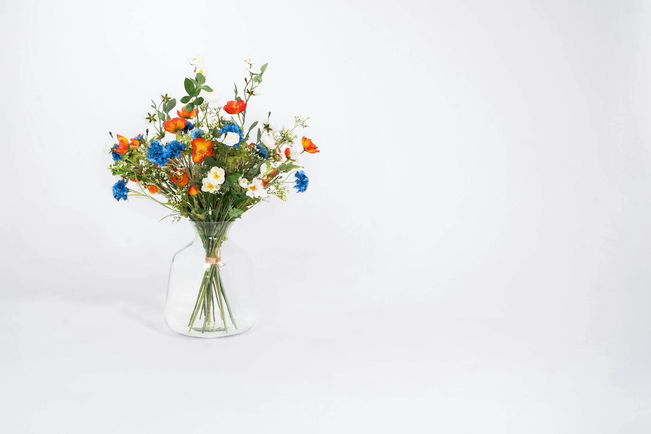 Faux meadow bouquet in glass vase
