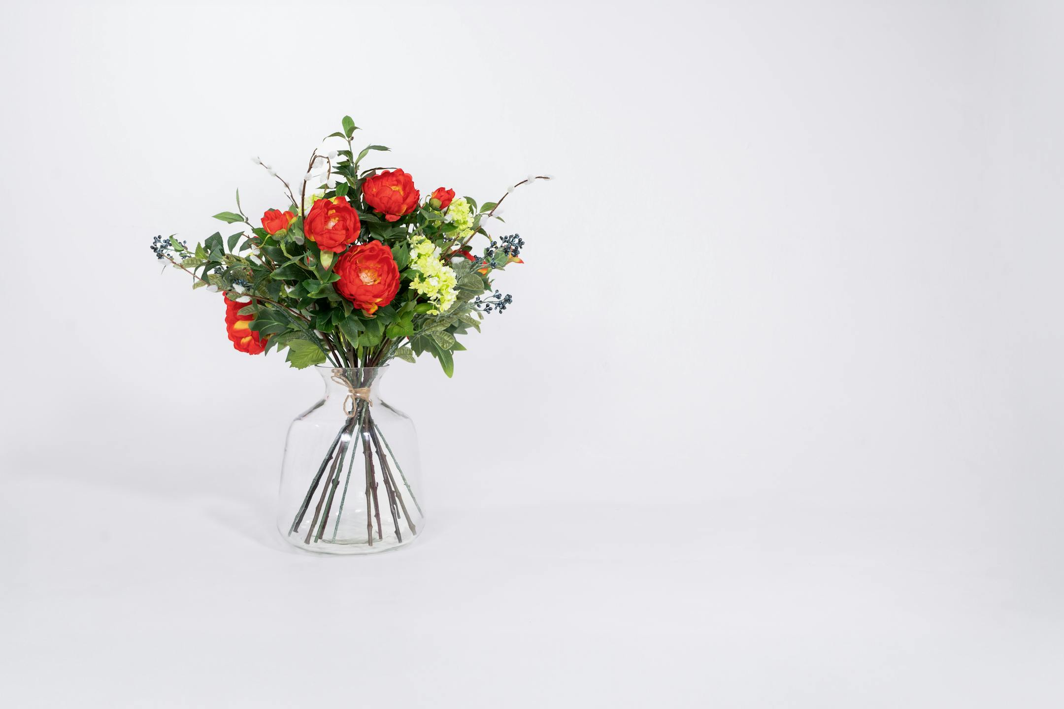 Artificial regal bouquet in glass vase