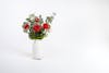 Artificial rosa bunch in white vase