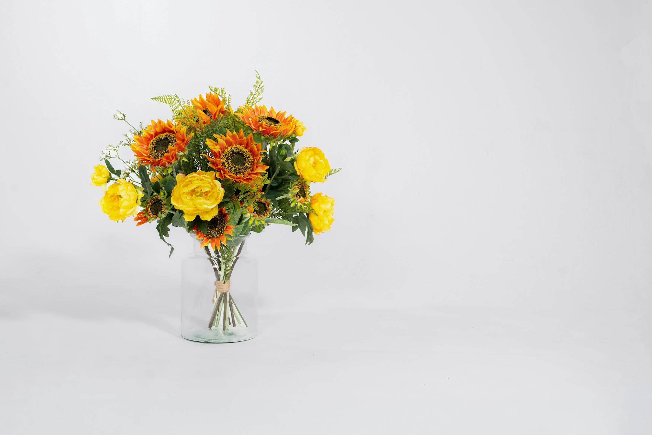 Artificial tequila sunrise bouquet in glass vase