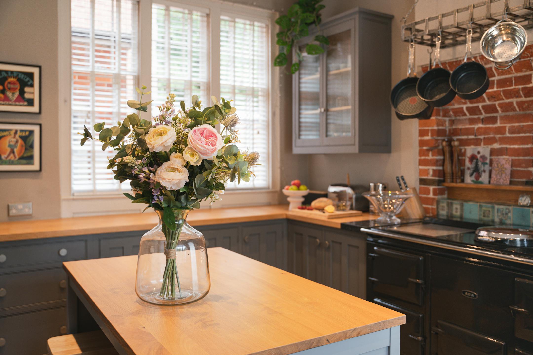 Artificial pink harmony bouquet on wooden kitchen island