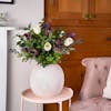 Faux twilight bouquet on pink side table with chair