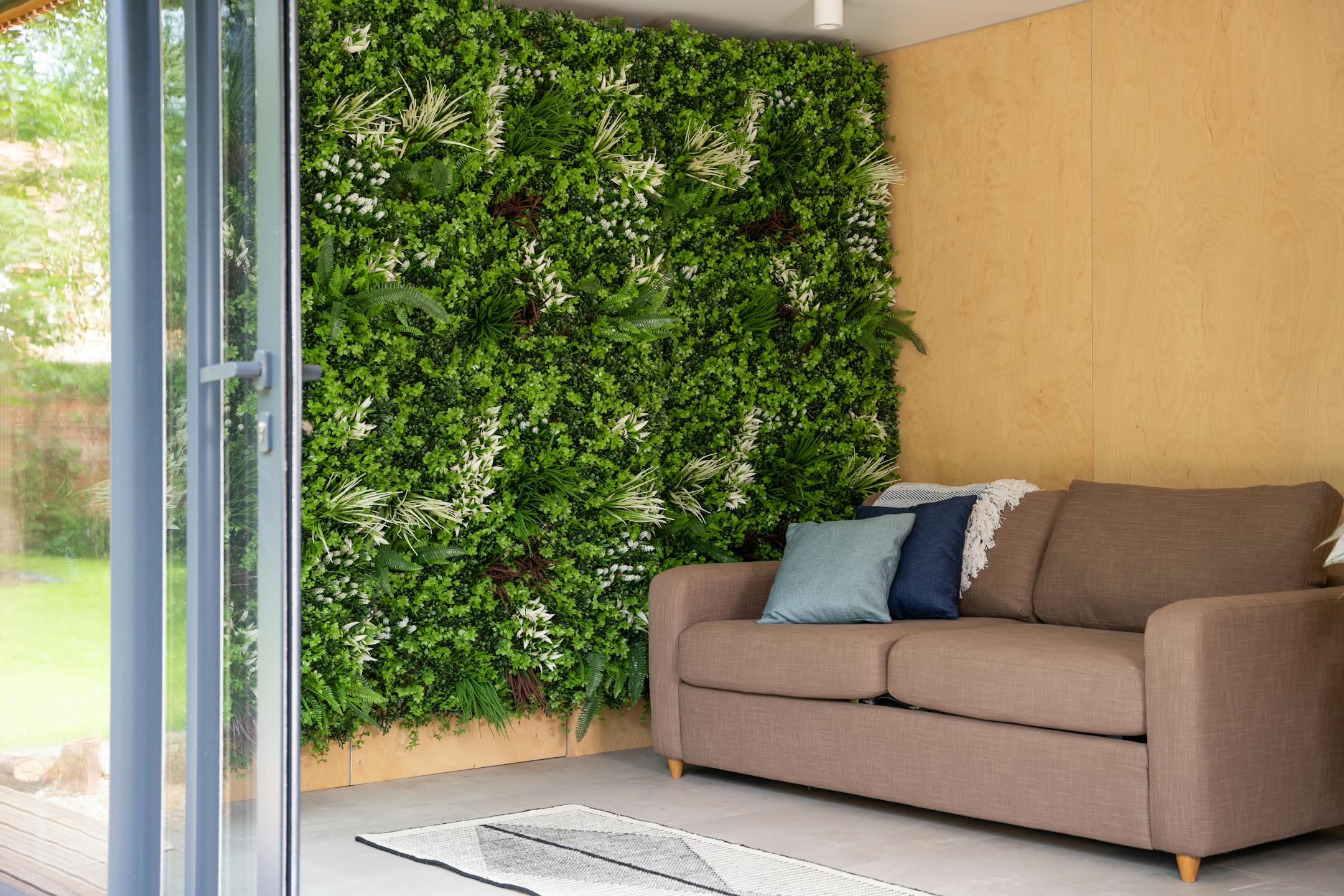 Faux galaxy green wall with brown sofa