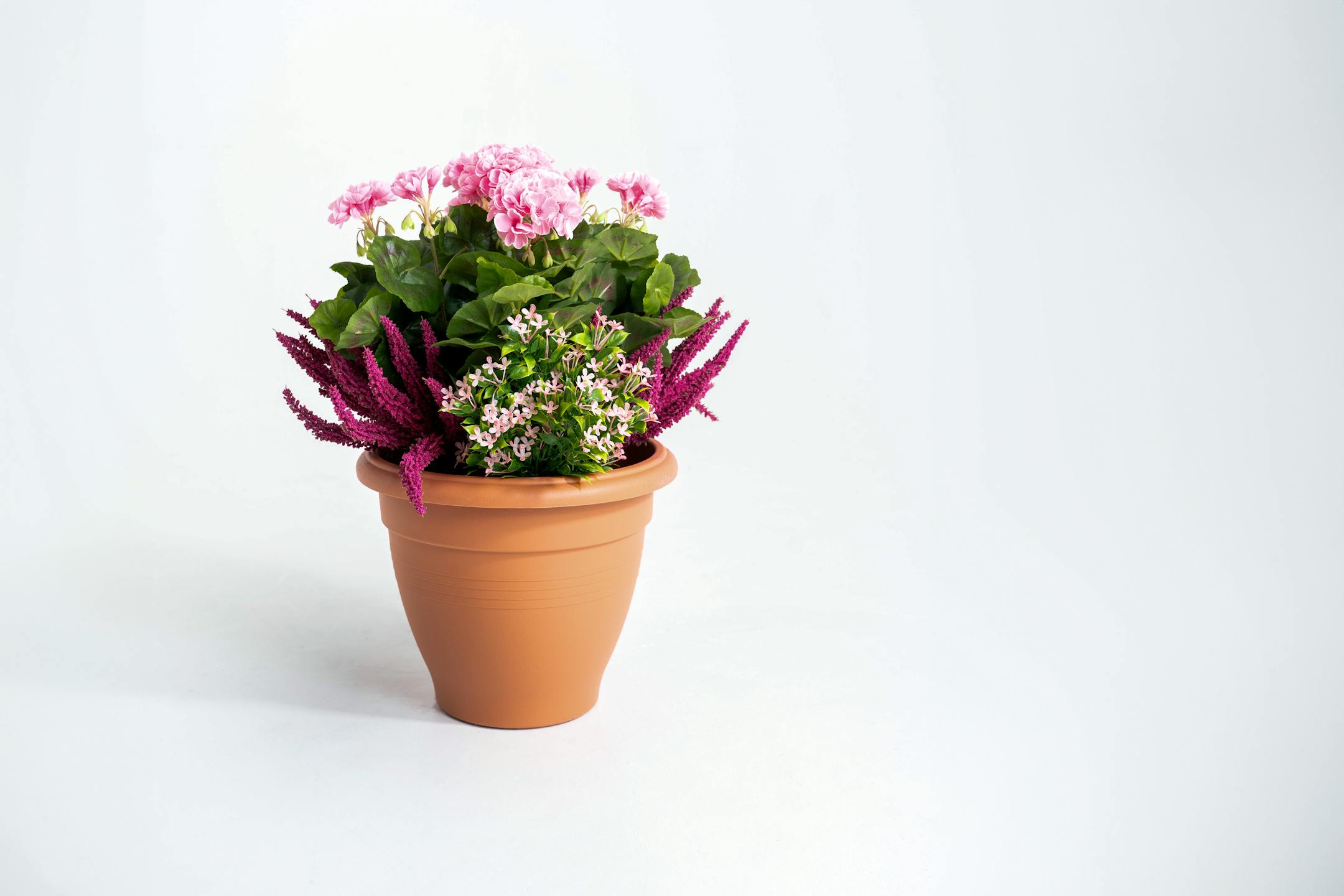 Artificial pink erica and geranium patio planter
