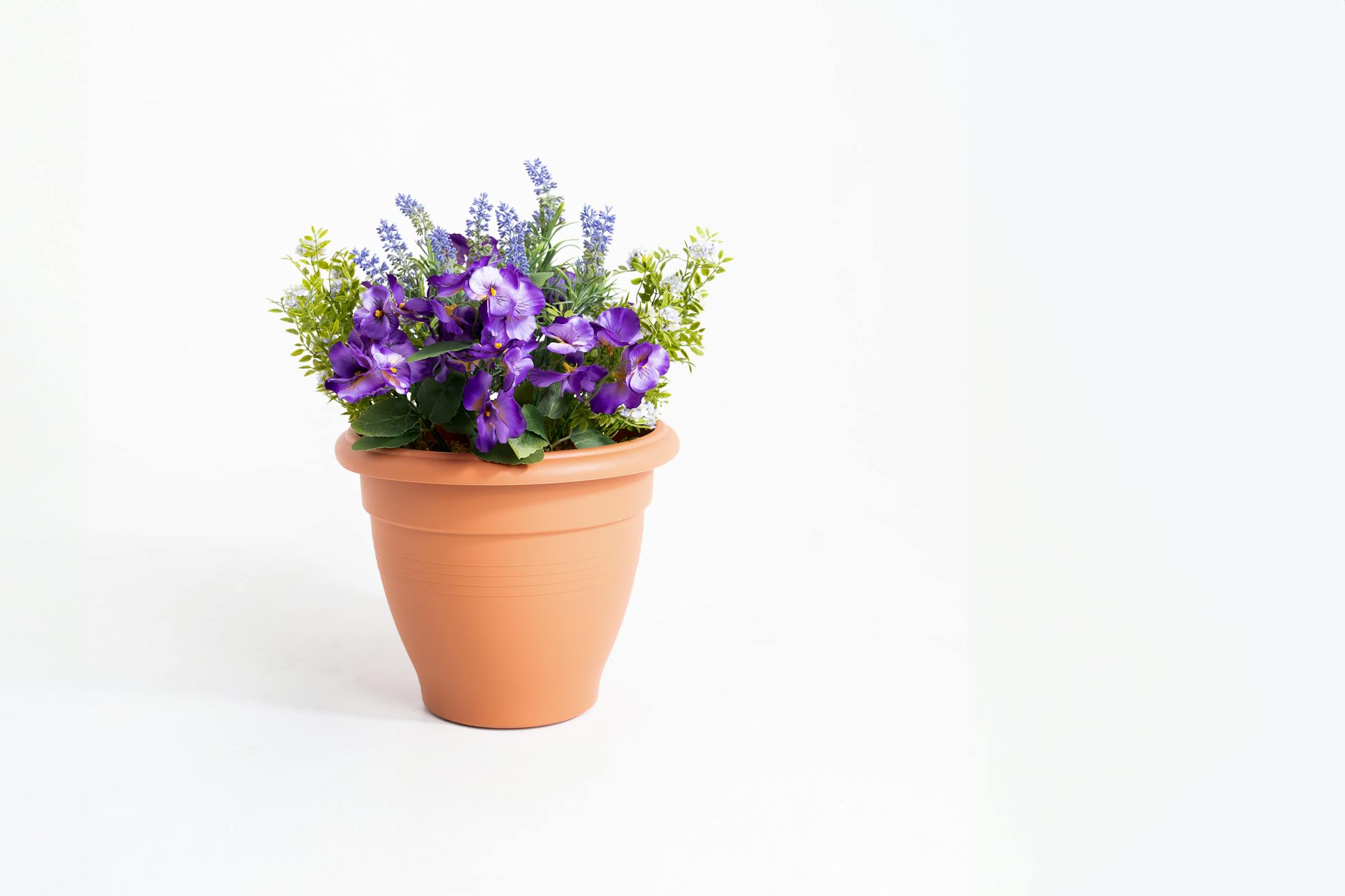 Artificial purple pansy and lavender patio tub