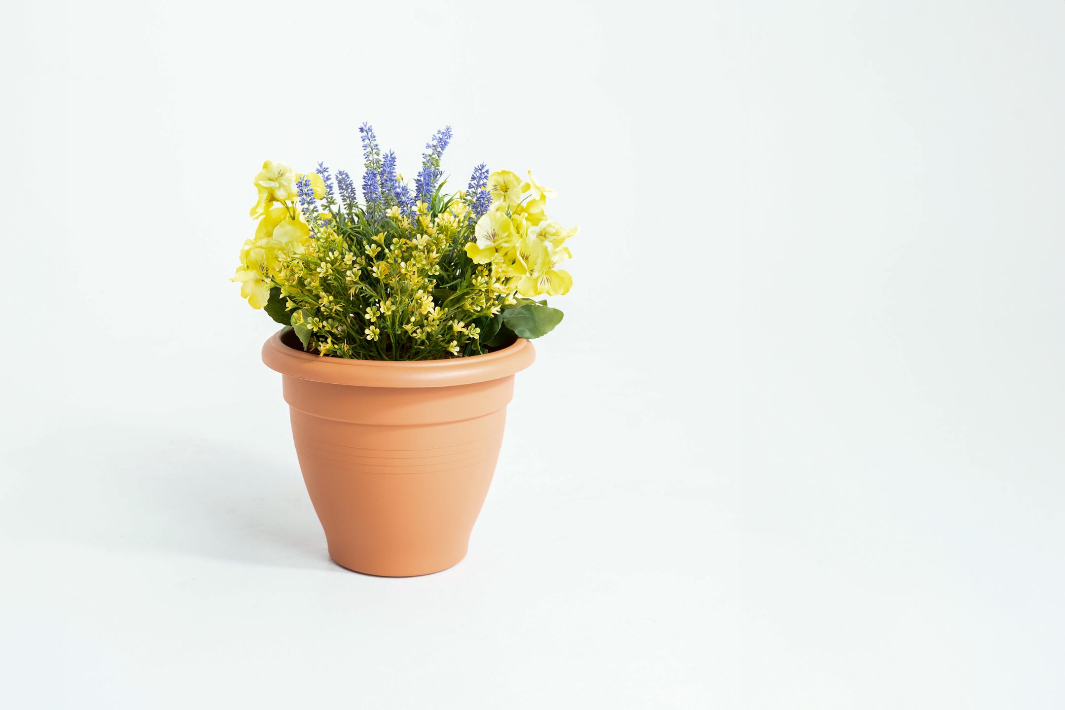 Artificial yellow pansy and lavender patio tub