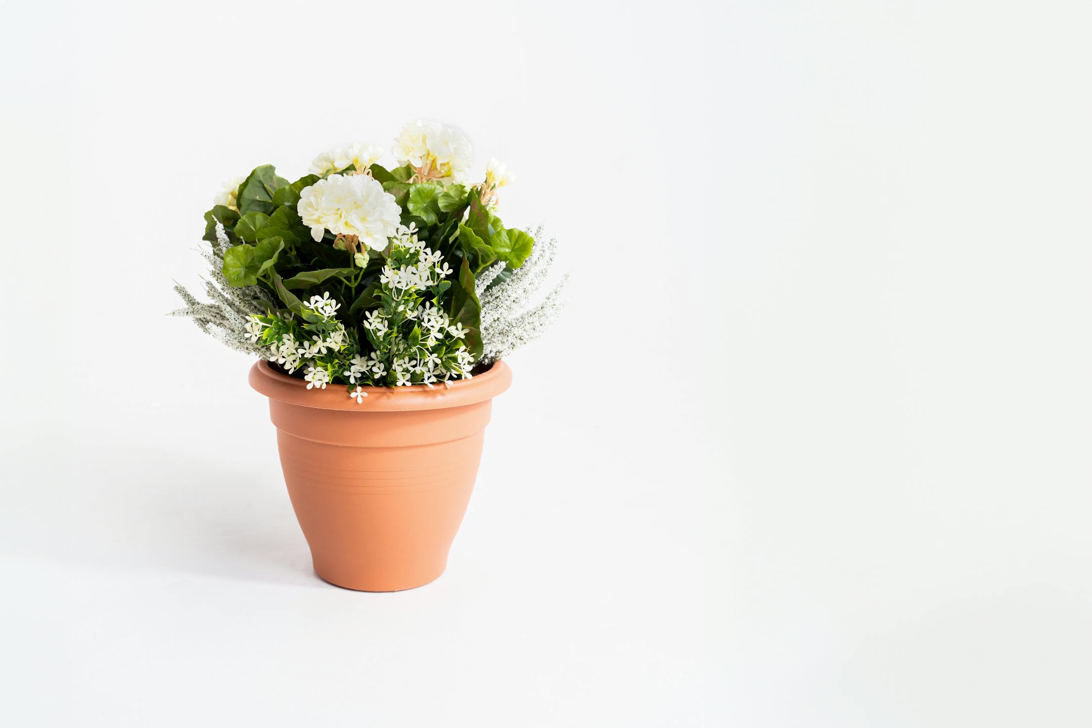Artificial cream erica and geranium patio planter