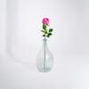 Dark pink artificial rose stem in glass vase