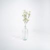 Artificial white gypsophilia spray in glass vase