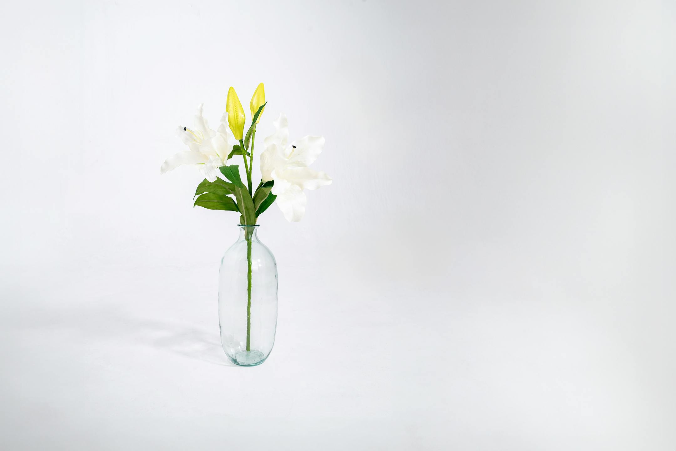 Artificial oriental lily stem in glass vase