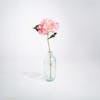 Pink artificial hydrangea stem in glass vase