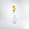 Triple yellow artificial sunflower stem in glass vase